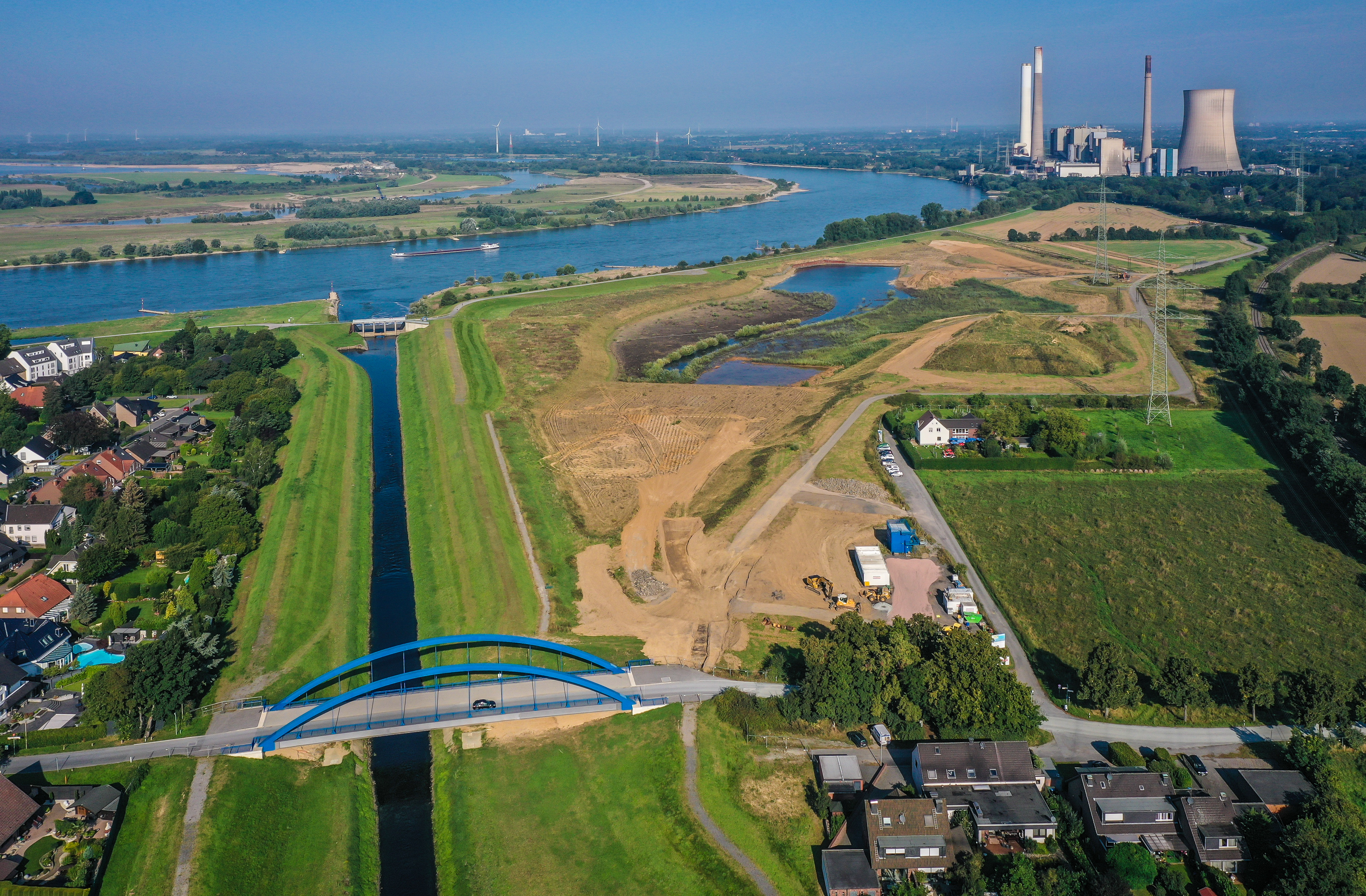 Vogelperspektivischer Blick auf die Genscher Mündung zwischen Feldern und Wiesen, darüber eine Autobrücke