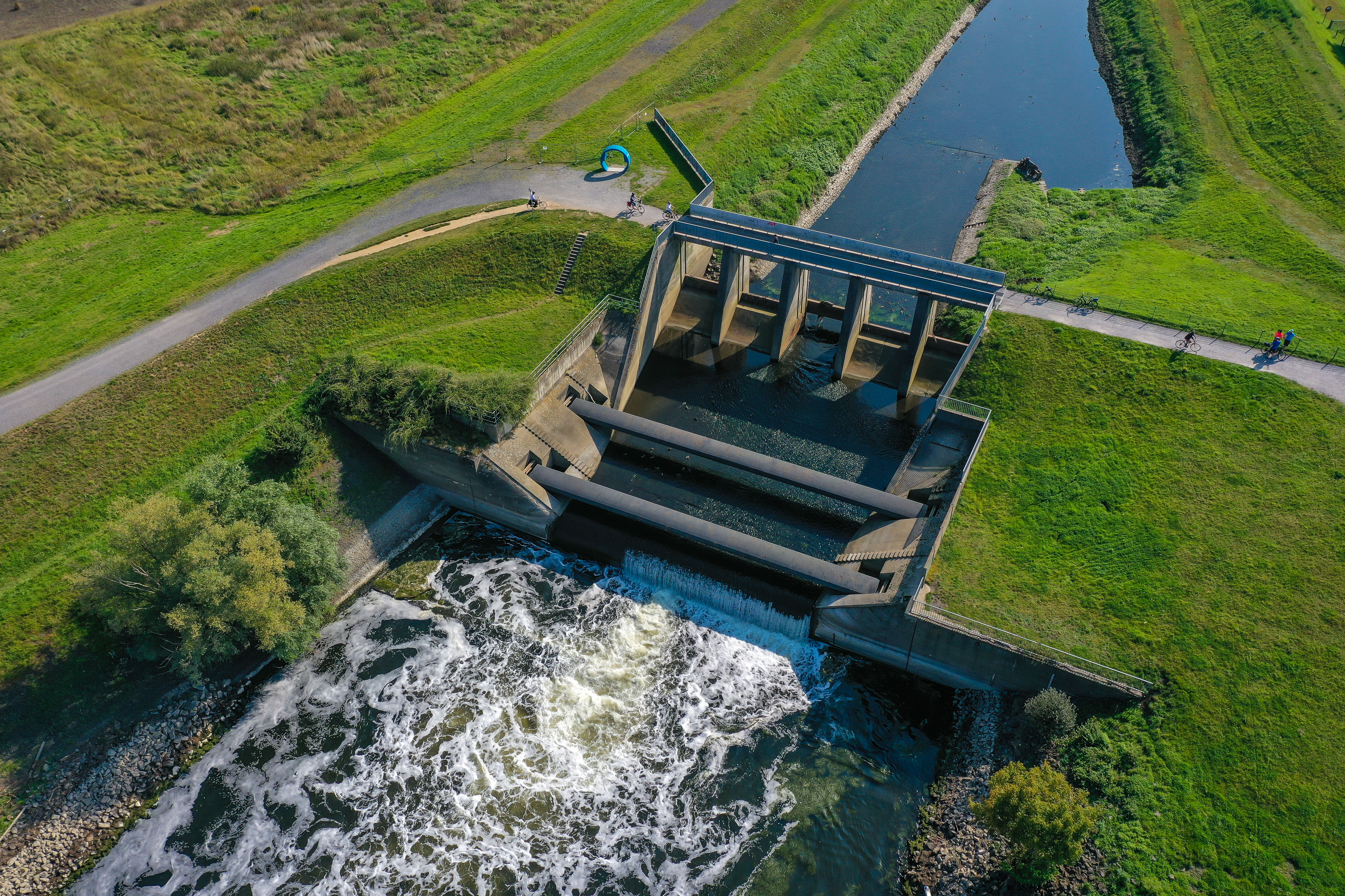 Blick von oben auf das (ehemalige) Absturzwerk in Dinslaken. Auf der einen Seite ruhiges Wasser, auf der anderen tobendes Wasser 